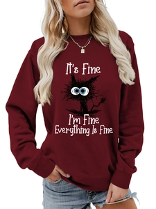 Close-up of funny black cat graphic and white text on burgundy cotton sweatshirt
