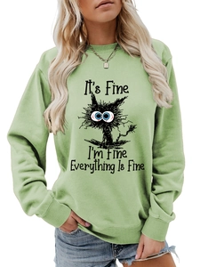 Detail of sage green sweatshirt with rib-knit neckline and It's Fine cat print