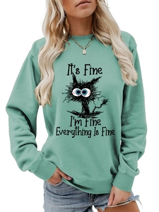 Detail of mint green sweatshirt with messy cat print and it's fine text graphic