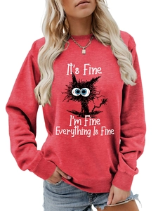 Detail of red crewneck sweatshirt with humorous cat graphic and It's Fine text print