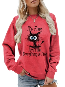 Detail of red crewneck sweatshirt featuring a funny cat graphic and It's Fine text print