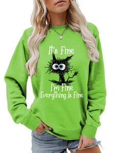 Detail of funny cat graphic and white text on grass green cotton blend sweatshirt