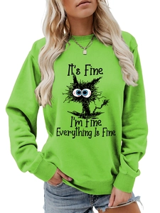 Detail of funny chaotic cat graphic and text on neon green crewneck sweatshirt