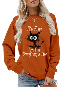 Close-up of burnt orange crewneck sweatshirt featuring a funny cat and text print