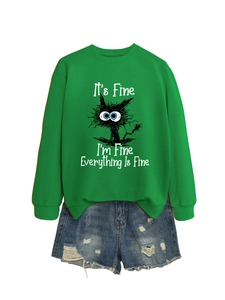 Detail of green crewneck sweatshirt with cat graphic and funny quote on white background