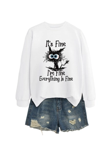 Flat lay of white crewneck sweatshirt with cartoon cat print and distressed denim shorts