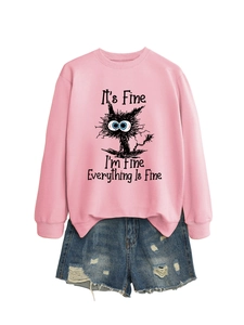 Detail of pink sweatshirt with humorous cat print and distressed denim shorts set