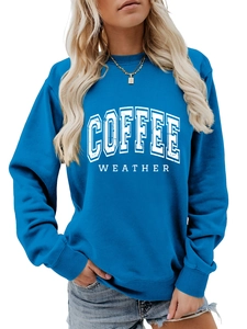 Detail of blue crewneck sweatshirt with white COFFEE WEATHER print and ribbed cuffs