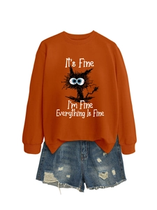 Flat lay of rust orange sweatshirt with funny cat text and ripped denim shorts