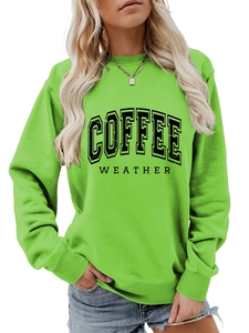 Close-up of bright green sweatshirt featuring black COFFEE WEATHER text print