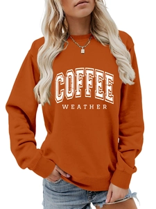 Detail of orange Coffee Weather sweatshirt featuring vintage white varsity lettering