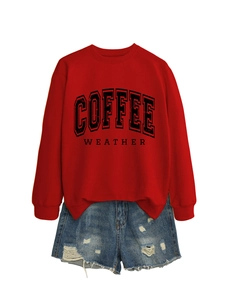 Detailed flat lay of red Coffee Weather sweatshirt with distressed blue denim shorts