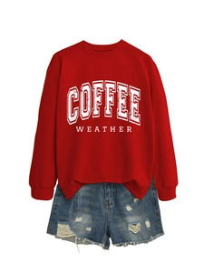 Flat lay of red Coffee Weather sweatshirt paired with distressed blue denim shorts