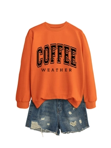 Orange Coffee Weather sweatshirt paired with distressed denim shorts on white background