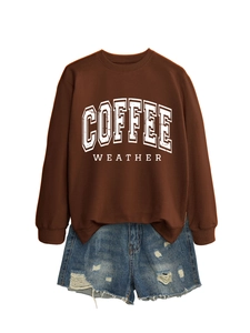 Flat lay of brown long sleeve Coffee Weather sweatshirt and distressed denim shorts