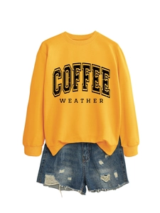 Detail view of ginger yellow coffee weather sweatshirt with blue distressed denim shorts