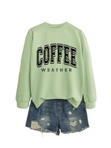 Close-up of COFFEE WEATHER print and distressed denim shorts with ripped details
