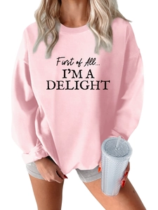 Close-up of First of All I'm a Delight text print on pink plush fleece sweatshirt