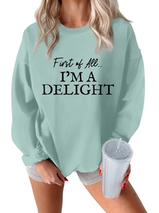 Close-up of the ribbed crewneck and black letter printing on this light green sweatshirt