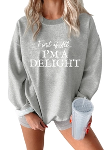 Close-up of thick light gray oversized sweatshirt with white letter print detail