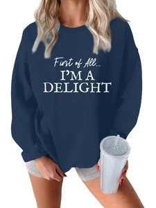 Detail of navy oversized sweatshirt featuring white 'First of All... I'M A DELIGHT' slogan