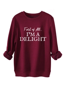 Macro detail of wine red sweatshirt fabric with white First of All I'm a Delight print