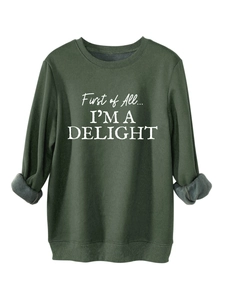 Detail of forest green fleece sweatshirt showing warm gray plush lining at the cuff