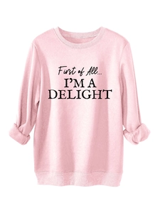 Detail view of the pink fleece sweatshirt featuring ribbed cuffs and a bold slogan