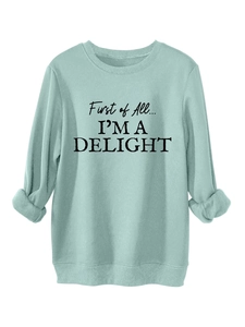 Detail of mint green sweatshirt with ribbed collar and black typography print