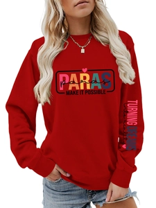 Detail of red crewneck sweatshirt featuring colorful chest print and arm lettering