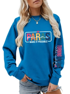 Detail view of bright blue sweatshirt showing chest logo and sleeve slogan print