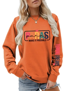 Close-up of bright orange sweatshirt with high-quality PARAS graphic print and sleeve slogan