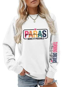 Close-up of pink and blue slogan print on sleeve of white oversized pullover sweatshirt