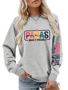 Detail of grey sweatshirt showing colorful PARAS print and sleeve text embroidery