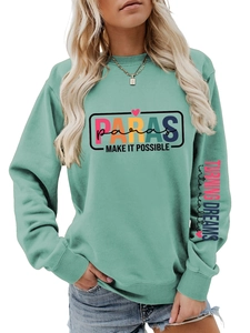 Detail of mint green sweatshirt with PARAS MAKE IT POSSIBLE slogan and sleeve print
