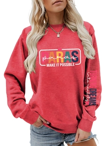 Detailed view of the red sweatshirt sleeve with Turning Dreams into Reality print