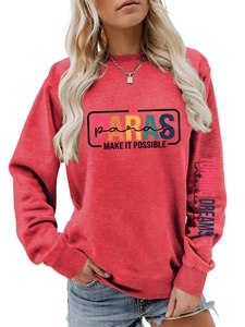 Detail of red crewneck sweatshirt with PARAS chest print and sleeve lettering