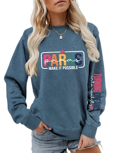 Detail of blue-grey marl sweatshirt featuring colorful chest print and sleeve text