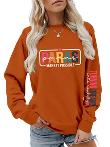 Detail of orange crewneck sweatshirt with PARAS print and sleeve lettering text