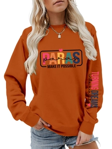 Detail of burnt orange sweatshirt showing Paras graphic and arm print design
