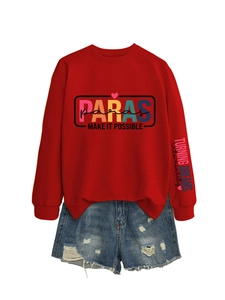 Detail of red crewneck sweatshirt with colorful PARAS print and blue ripped denim shorts