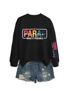 Flat lay detail of black sweatshirt with colorful PARAS print and denim shorts