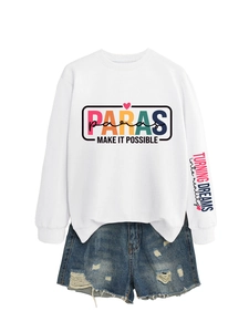 Flat lay of white sweatshirt with PARAS colorful lettering and ripped denim shorts