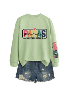 Flat lay of light green sweatshirt with Paras graphic print and denim shorts outfit