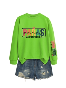 Detail of neon green PARAS graphic sweatshirt paired with distressed blue denim shorts