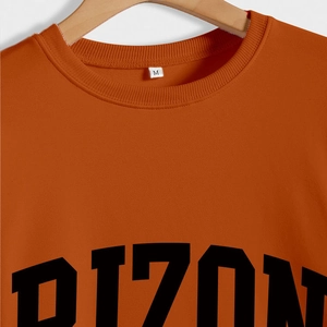 Detail of warm orange crewneck sweatshirt with black Arizona block lettering print