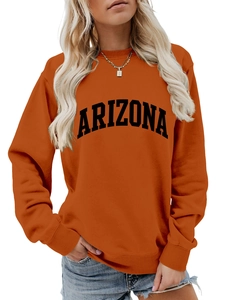Close-up of the black Arizona letter print on a casual orange crewneck sweatshirt