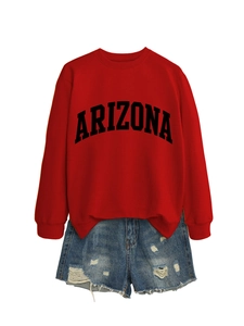 Flat lay of red Arizona sweatshirt with letter print and frayed blue denim shorts