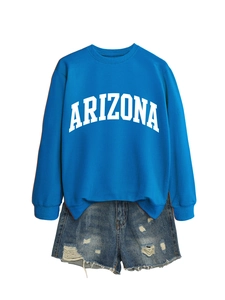 Flat lay of blue Arizona sweatshirt with distressed denim shorts for casual style