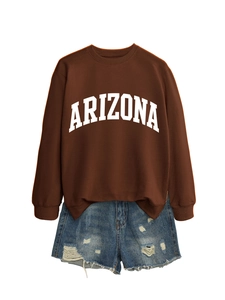 Detail of Arizona oversized brown sweatshirt paired with distressed blue denim shorts